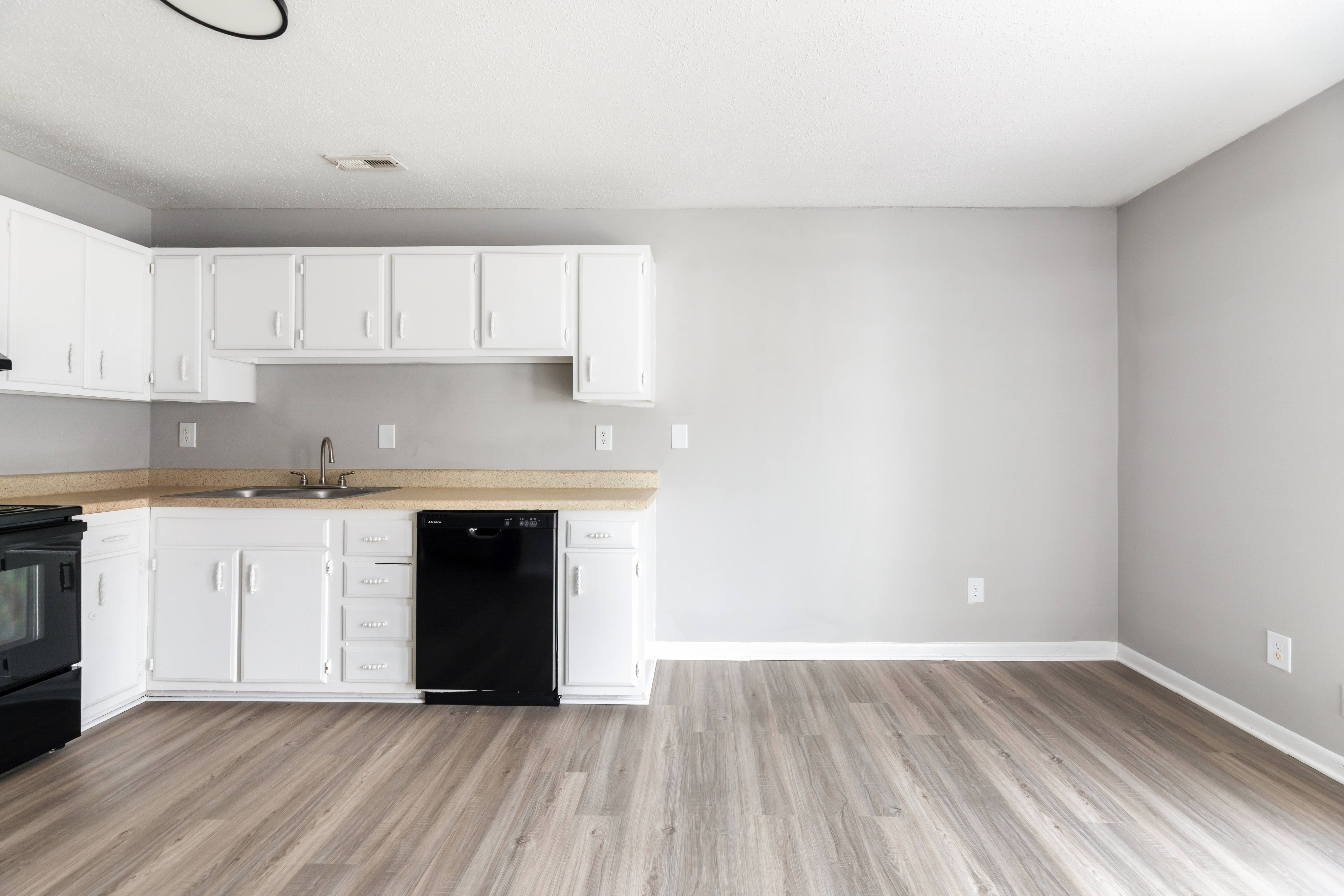 A kitchen with black appliances and white cabinets.at Lauradale, North Carolina